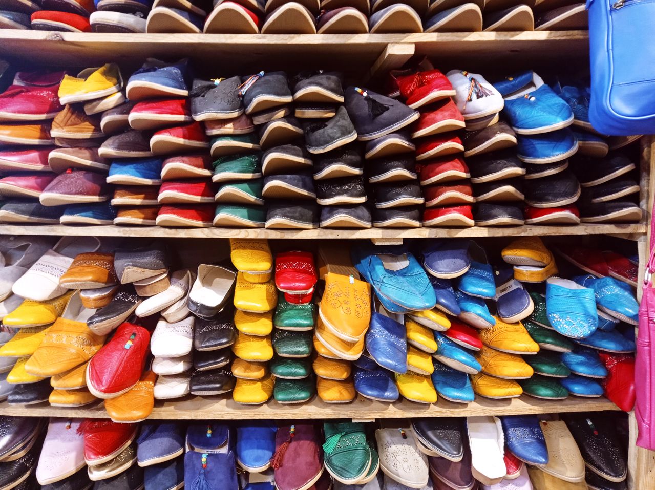Kleurrijke leren slippers op houten planken